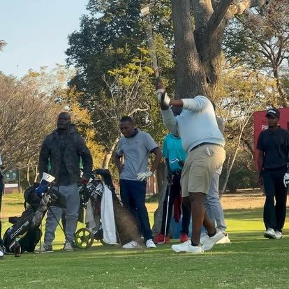A golfer mid-swing on the course