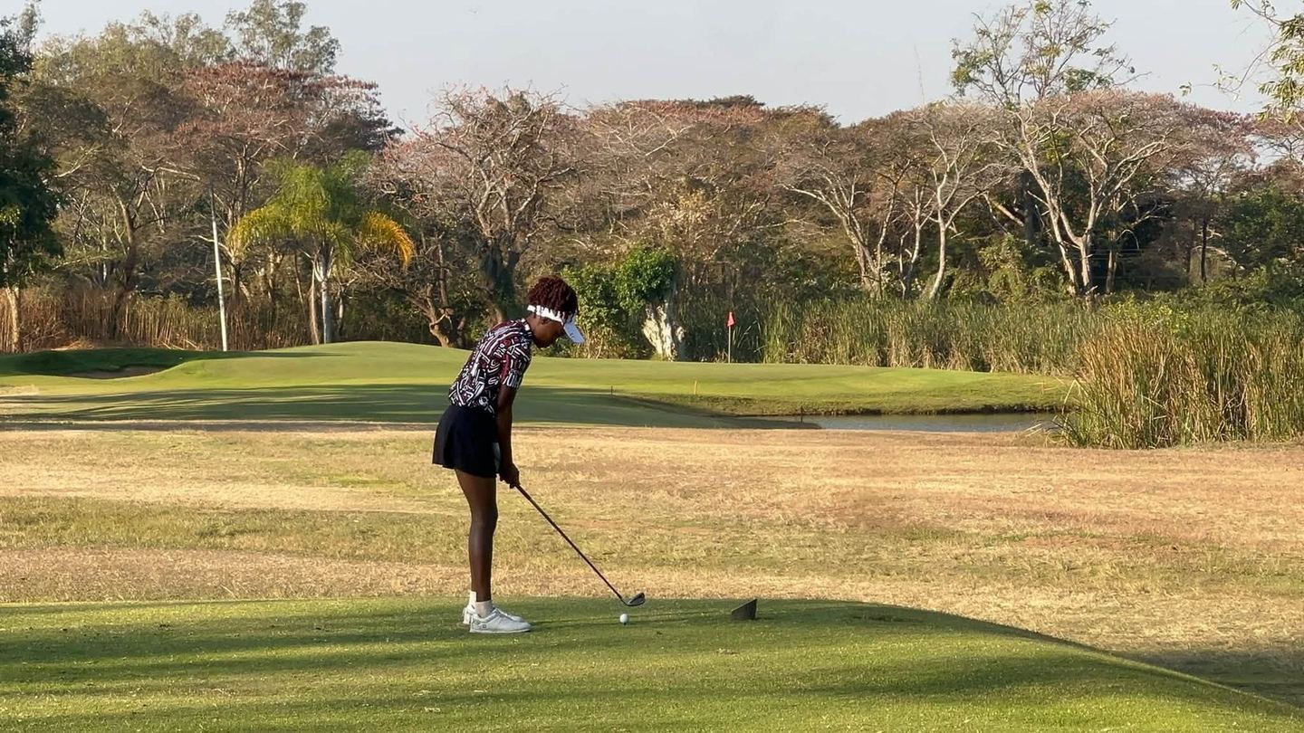 A golfer tees off towards the green at Lusaka Golf Club